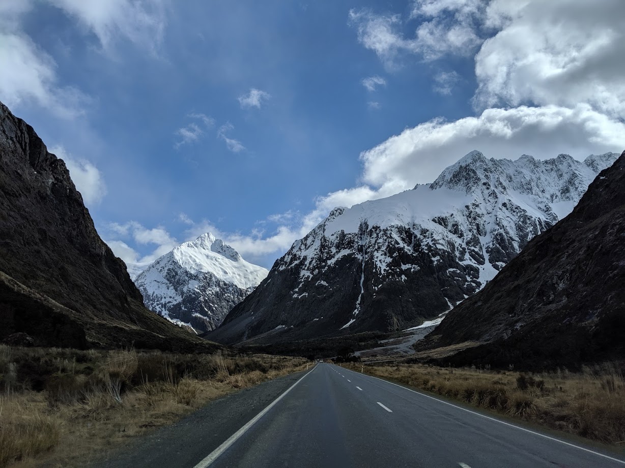 a road with snow covered mountains