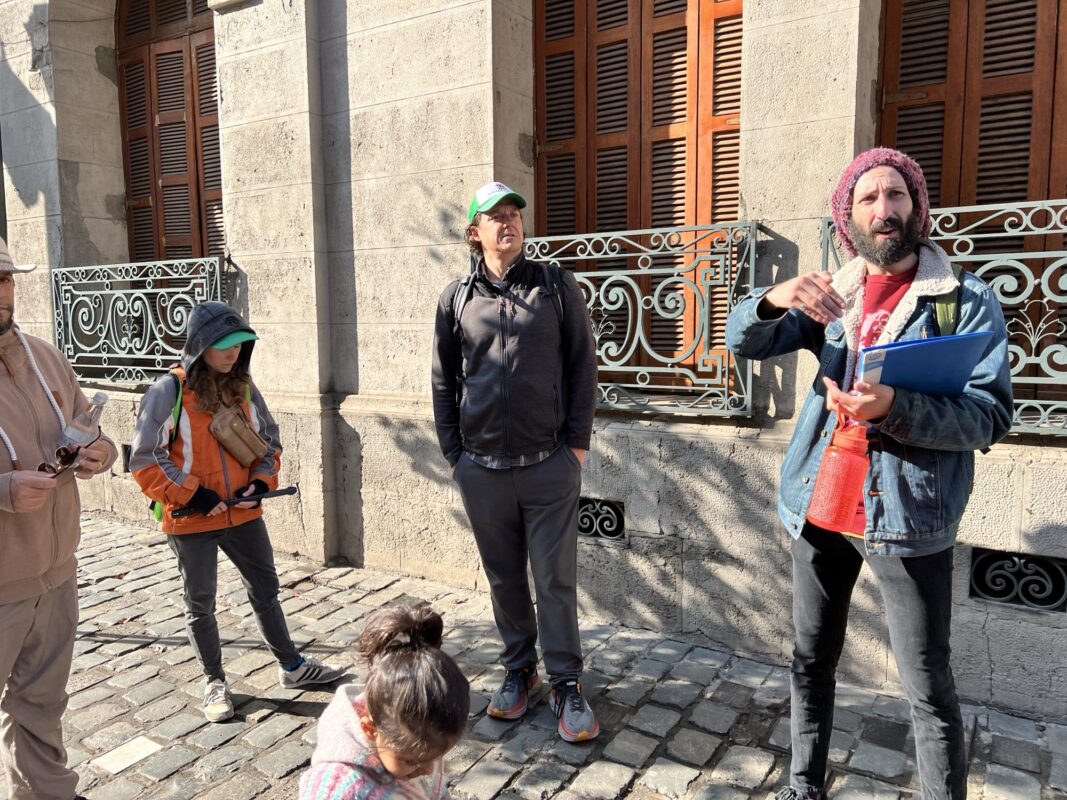 a group of people standing on a cobblestone street